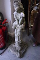 A cast stone garden statue, "Spring", young girl sat on an ivy covered column, 33 1/2" high