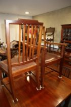 A set of eight mahogany and line inlaid Sheraton Revival dining chairs with leather drop-in seats,