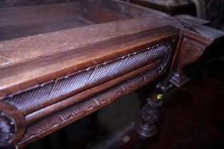An Edwardian walnut fold-over card table, on carved acanthus and reeded supports united by an
