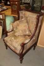 A French carved and painted open armchair, upholstered in a patterned fabric, on turned and carved