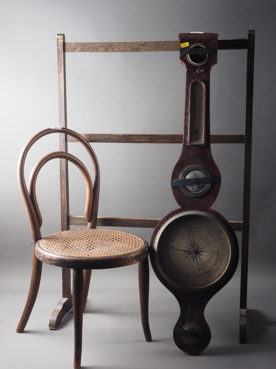An Edwardian mahogany and line inlaid barometer (numerous losses and damages), a child's bentwood