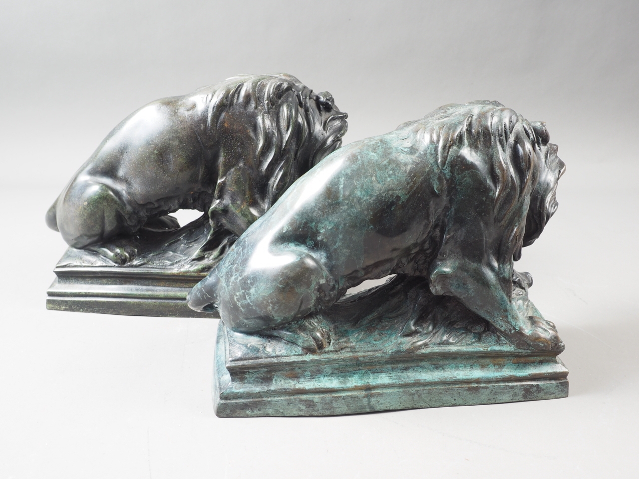 A pair of patinated brass lion doorstops with wild boar, 8" high - Image 2 of 2