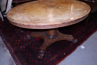 A 19th century figured walnut loo table, on turned column and quatrefoil base, 53" wide