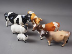 Four Beswick cows and two Beswick sheep (chip to one brown cow's hoof)