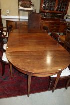 An early 19th century 'D' end dining table with centre drop leaf section and extra leaf, on square