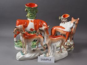 Three 19th century Staffordshire spill vases and a pair of greyhounds (restorations), largest