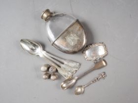 A Georgian silver condiment spoon, three silver thimbles, a silver decanter label and a silver