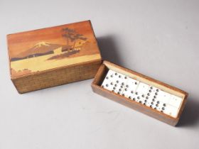 An ebony and bone dominoes set, in case, and a Japanese puzzle box