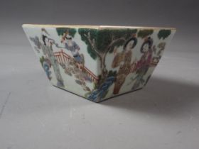 A Chinese porcelain square tapered dish with figures in a landscape decoration, seal mark to base,