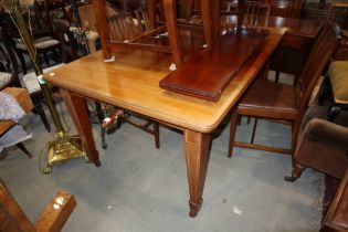 An Edwardian mahogany and satinwood inlaid extending dining table with two extra leaves, on square