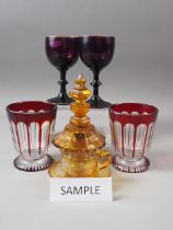 A pair of 19th century faceted beakers, an amber flashed and engraved cup and saucer and other