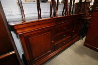 A Grange cherrywood sideboard, fitted three drawers over cupboards with further central drawers