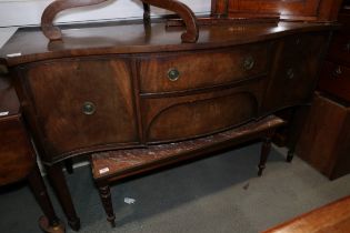 A mahogany serpentine sideboard, fitted two side cupboards and two central drawers, on square