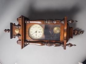 An early 20th century walnut cased eight-day wall clock, 27" high