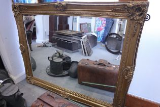 A bevelled plate rectangular wall mirror, in ornate gilt frame, plate 36" x 48"