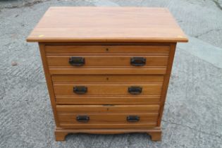 A satin walnut chest of three long drawers, 33" wide x 20" deep x 33" high