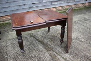 A Victorian oak and mahogany rectangular top wind-out dining table with one extra leaf,