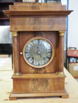 An early 19th century Danish figured mahogany mantel clock with silvered chapter ring and eight-