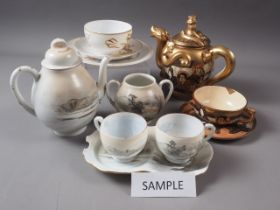 An early 20th century Satsuma figure decorated teaset and a Japanese eggshell part teaset