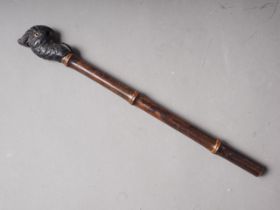 A 19th century carved ebony parrot head parasol handle with bamboo stem, 12" long overall