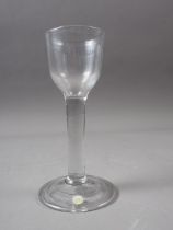 An 18th century cordial glass on folded foot, 5" high