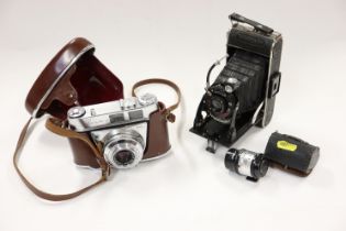 A Voigtlander vest pocket camera and a Kodak camera