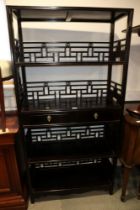 A Chinese ebonised hardwood open bookcase, fitted two centre drawers, 34" wide x 14" deep x 68" high