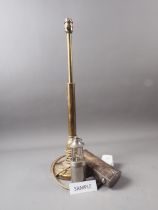A brass table lamp, a student's silver plated lamp, a rise and fall light and a miner's miniature