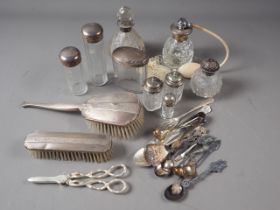 Four silver mounted toilet jars, a silver mounted scent spray, two silver backed hairbrushes, etc