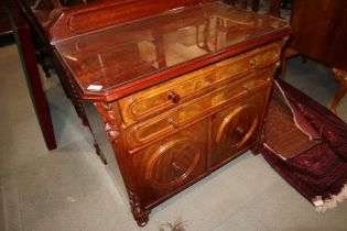 A walnut ledge back side cabinet, fitted two long drawers over two short deep drawers, on carved