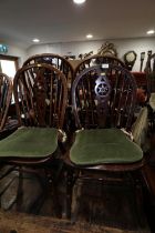 A pair of 19th century Windsor star and spindle back dining chairs with elm panel seats, on turned