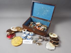 A number of lady's powder compacts, a doll's teaset, a group of figure decorated pill boxes and a