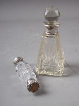 A cut glass and silver mounted double-ended scent bottle, and another similar scent bottle and