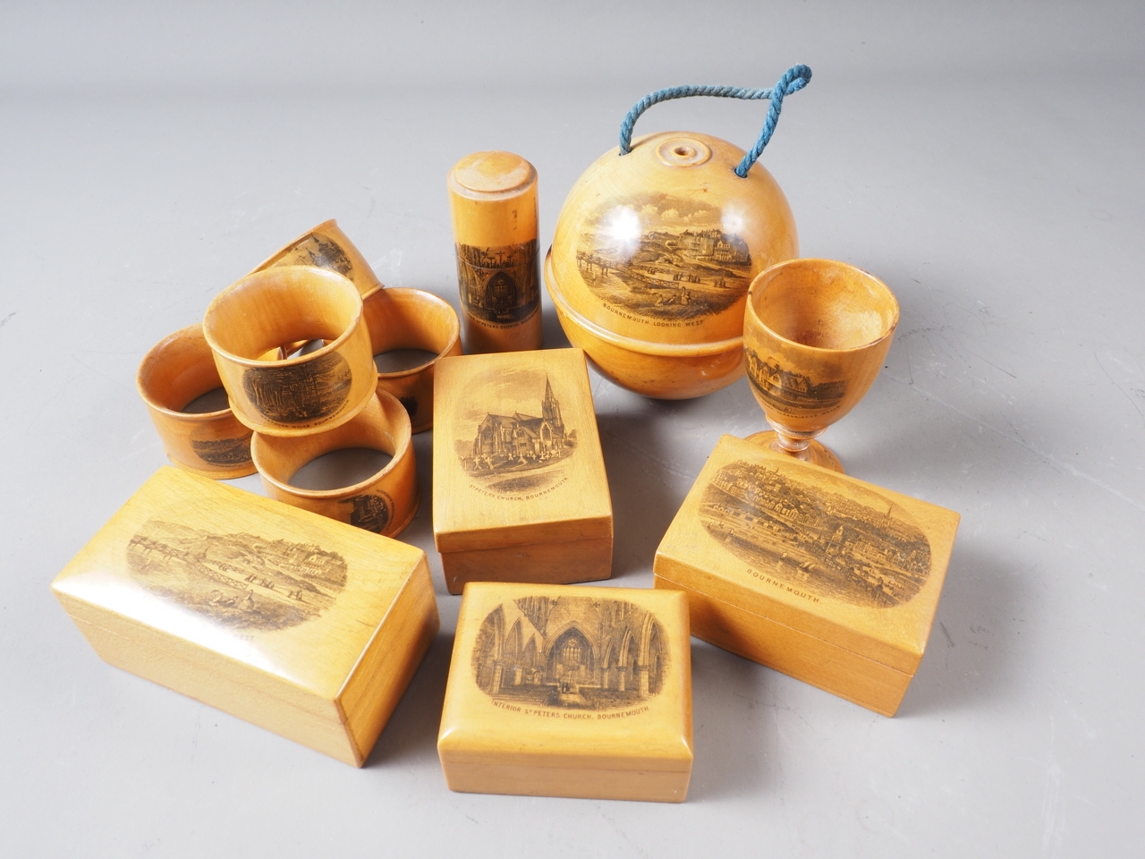A set of five Mauchline ware napkin rings, a string box, four boxes and covers and an eggcup