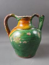 An early 19th century green and yellow glazed jug, 10" high