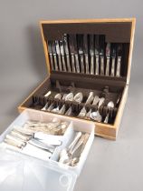 A pale oak canteen of "Grecian" pattern silver plated cutlery, matching loose plated cutlery and