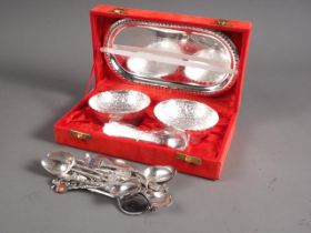 A pair of white metal embossed bowls and spoons, in case, and a collection of Continental souvenir