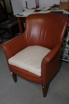 A 1950s leather tub seat armchair with loose seat cushion, on square taper supports