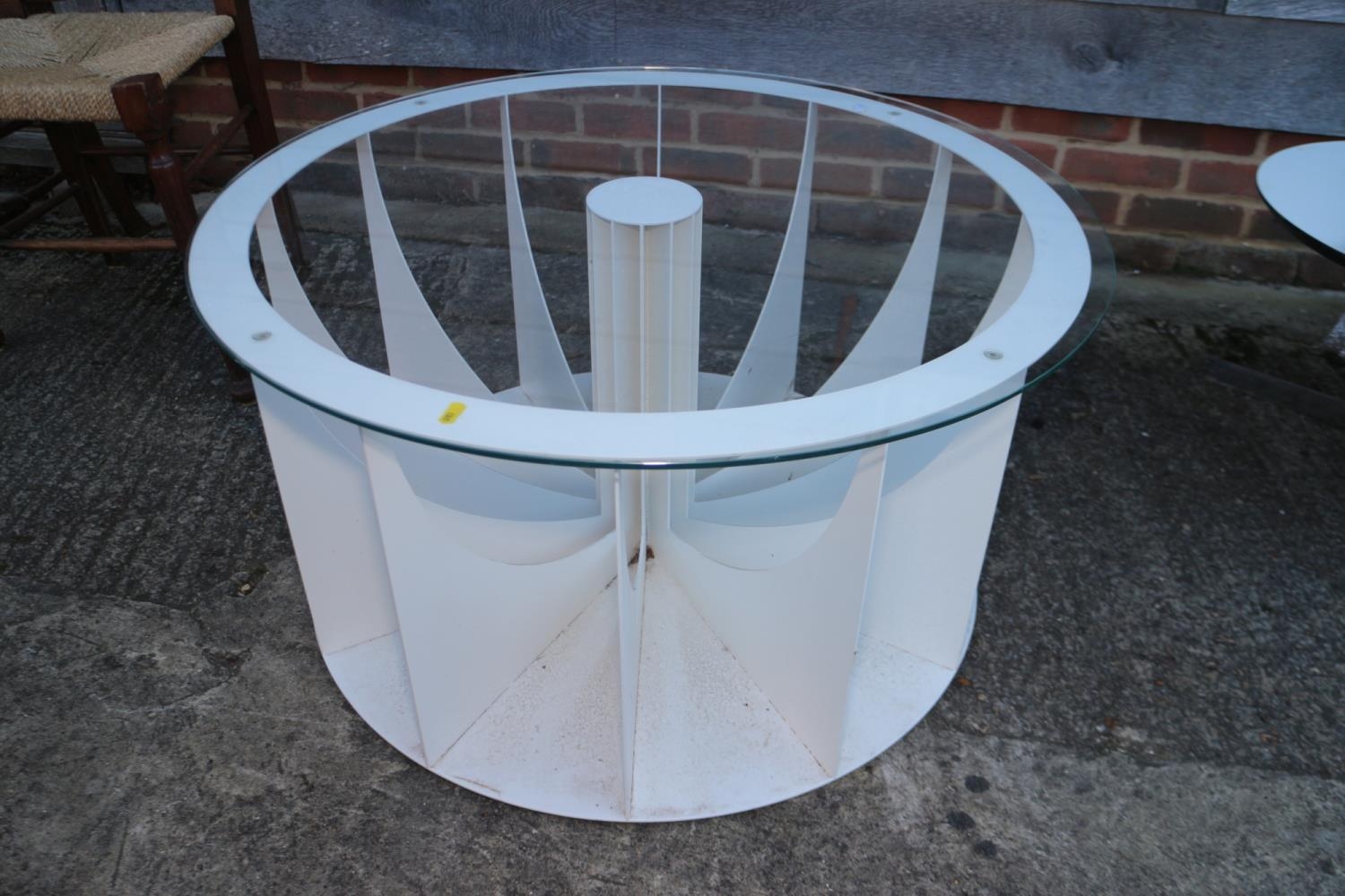 A modern circular white painted metal glass top table with central radiating base, 33" dia x 17 1/2"