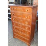A walnut chest of seven long drawers with fielded panel fronts, on bracket feet, 31" wide x 15" deep