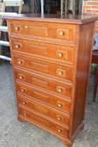 A walnut chest of seven long drawers with fielded panel fronts, on bracket feet, 31" wide x 15" deep