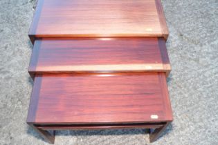 A nest of three 1960s Danish rosewood occasional tables, on square supports, 24 1/2" wide x 13 1/