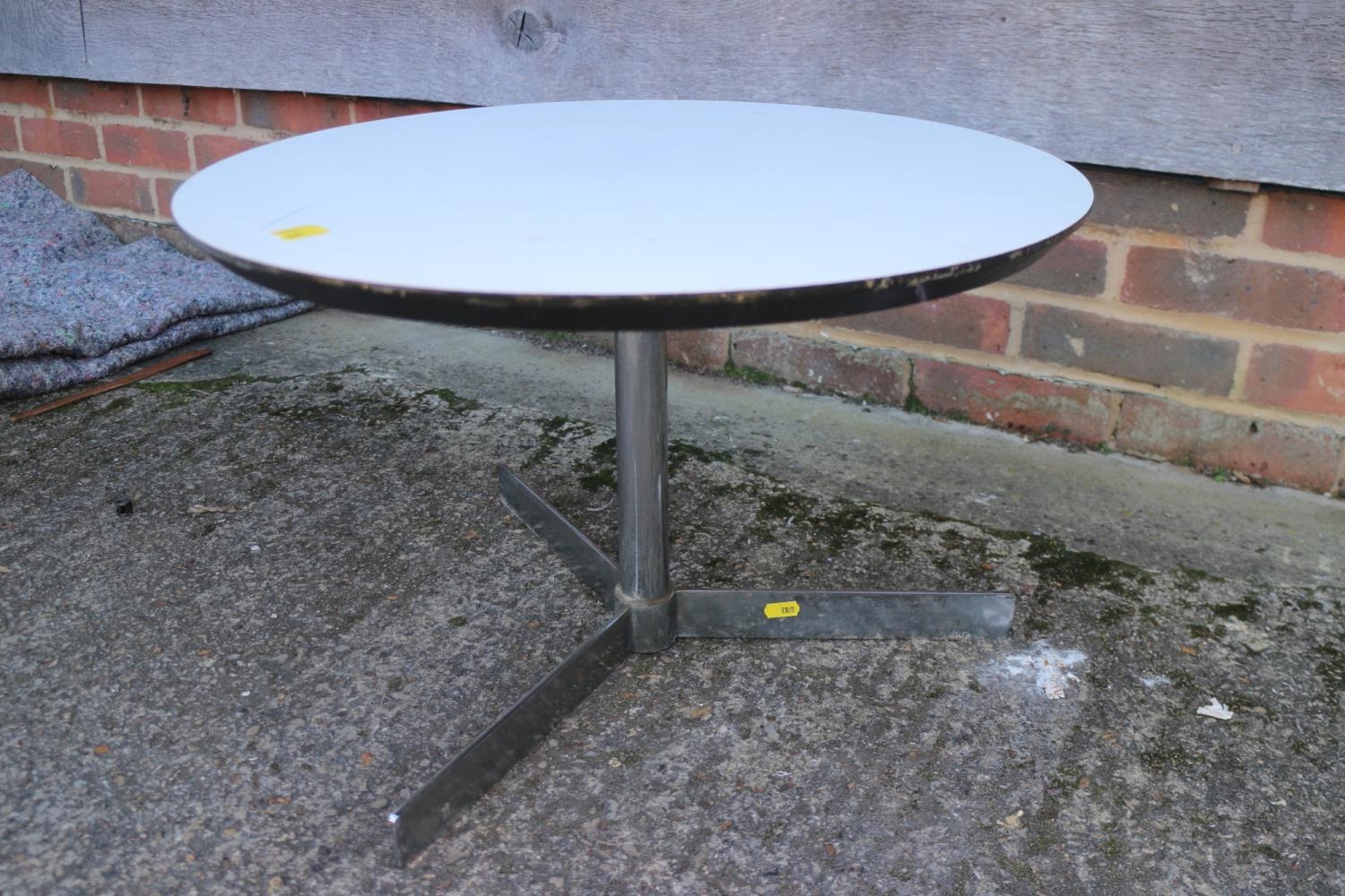 A 1960s circular laminate top low occasional table, on tripod splay support, 22" dia x 14" high