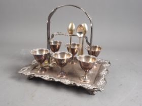 A silver plated six-egg table cruet