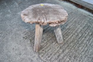 A Wanderwood rustic three leg stool, 13" dia x 13" high