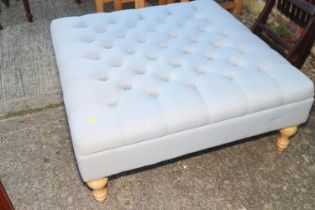 A modern square ottoman/stool, button upholstered in a grey linen, 36" square x 16" high