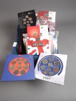 A collection of Royal mint brilliant uncirculated coins sets, a cased 1953 specimen coin set, and