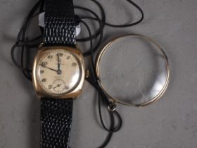 A gentleman's 1930s Omega wristwatch, in Dennison case and leather strap, and a yellow metal