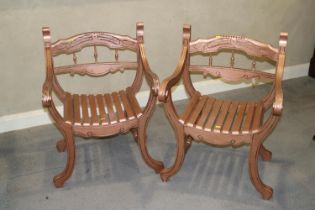 A pair of "copper" painted 'X' frame open armchairs with slatted seats