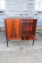 A 1960s Danish rosewood drop front music/drinks cabinet enclosed two doors, on tapering supports,